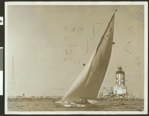 Sloop sailing past a lighthouse at the San Pedro breakwater, 1929