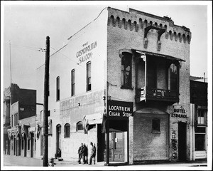 Exterior view of the Old Fire House in the Los Angeles plaza, showing men congregated by the entrance, 1920