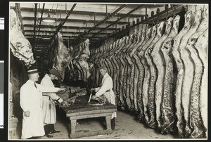 Wilson & Company cooler showing butchers quartering beef, ca.1930