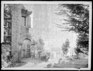 Mission Santa Barbara, showing door and window of church from cemetery, California, 1898