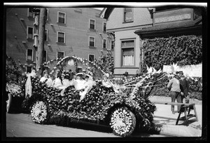 People in a flower-covered automobile at the Fiesta de Los Angeles Parade, ca.1915