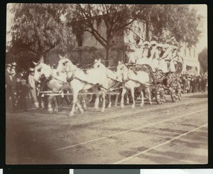 Unidentified horse-drawn carriage filled with ladies in fancy dress