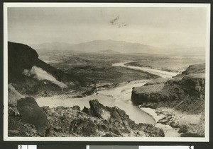 Unidentified river winding through what appears to be a desert valley, ca.1950