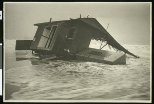 Small house being swept to sea in Long Beach, ca.1910