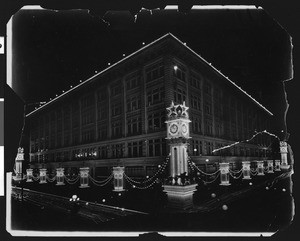 May company building decorated for Shriner's electrical parade, ca.1910