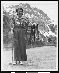 Lucille Almour holding a fish catch of rainbow and loch leven trout, at June-Grant Loop, Fern Creek, ca.1930