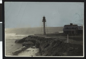 Lighthouse at Point Loma next to a building and the ocean, ca.1900