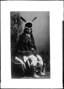 Portrait of Apache Indian Ne-tech-i-ta sitting on stool, Arizona, 1884