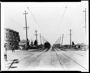 Electric railroad train preparing to stop at One Hundred Third Street in Watts, 1910