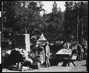 Campers preparing a meal, ca.1920