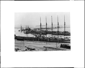 Birdseye view of the San Pedro Harbor, showing schooners loading lumber to railroad freighters, ca.1900