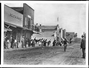 Spectators watching a bicyclist on Beacon Street, San Pedro, ca.1907