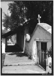 Exterior view of the Pala Mission, showing a sidewalk