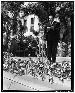 Man speaking during the dedication of Simon Bolivar Plaza on Pan American Day, Los Angeles