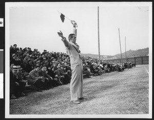 Referee officiating at an event, ca.1930