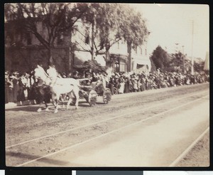 Horse-drawn float in a parade, ca.1900