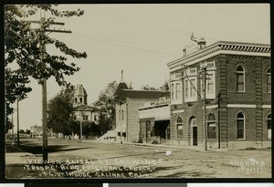 Alisal Street showing the Troop C Building, the Episcopal Church, and the Court House in Salina, Monterey, ca.1900