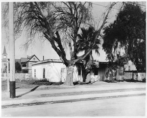 A disheveled adobe house in a neighborhood of larger homes, ca.1890