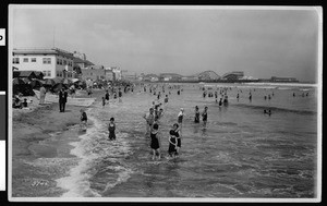 Bathers at the Long Beach shore, with the amusement park in the distance, ca.1925