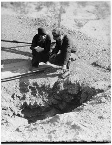 Couple looking at the ground at a funeral in the desert