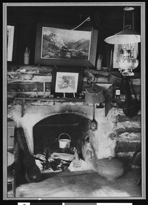 An interior view of a fireplace of a log cabin, ca.1930-1940