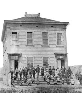 Portrait of students posed outside the Spadra School, 1867