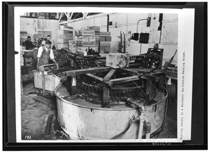 Workers packing and washing lemons, ca.1925