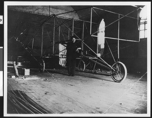 Glenn Martin posing with his first airplane frame, ca.1916