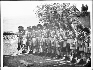 Antelope priests in line in front of a kiva during a Snake Dance Ceremony at Oraibi, Arizona, ca.1896