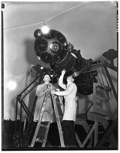 Two scientists checking astronomical instruments at the Griffith Observatory, ca.1930-1950