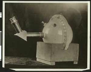 Spherical object with attached arm on a wooden platform, ca.1910