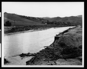 Stream of water and flood damage at Universal Studios' back lot at Barham Boulevard, Burbank, 1938