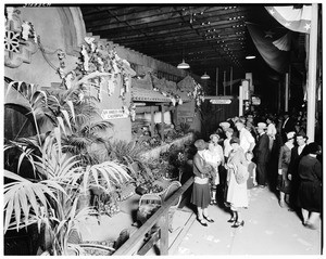 People looking at a diorama depicting Los Angeles County