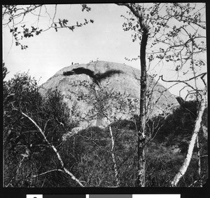 People at the top of Eagle Rock, shown from a distance, 1908