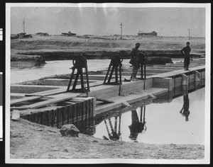 View of two men on the Owens River and Los Angeles Aqueduct, ca.1913