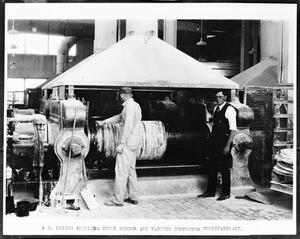 Workers mixing and milling crude rubber and various compounds at the Goodyear Tire and Rubber Company plant