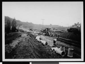 Storm drain construction, showing rows of pipe sections