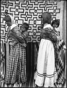 Two young Walapai Indian mothers with their children on their backs, Hackbury, Arizona, ca.1900