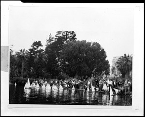 Boys launching boats on a lake in Echo Park during the Echo Park Boat Tournament in Los Angeles, ca.1930