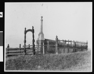 View of the Louis Wolf Monument, possibly a burial vault, on a know overlooking Temecula Valley, ca.1900