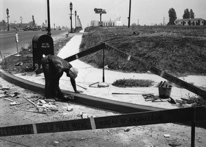 Masonry worker finishing new curbing on Wilshire Boulevard, 1930-1939