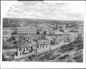 View of the Pico House, Masonic Temple and the Plaza area from a hill overlooking Spring Street and Main Street in Los Angeles, December 1, 1869