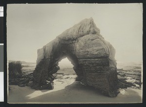 Footprints leading underneath Cathedral Rock on the beach in La Jolla, ca.1900