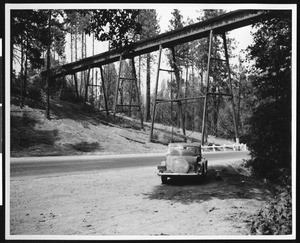 Automobile below a trestle of the old Central Pacific Railway Crossing near Highway Forty, 1936