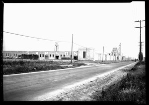 Exterior view of the Samson Rubber Company showing a water tower on the roof, Compton