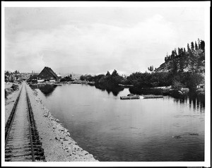 View of the Truckee River near Lake Tahoe, showing locomotive tracks, ca.1900