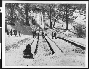 People at a toboggan slope at Big Pines mountain camp, ca.1930