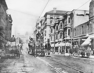 Horse-drawn fire wagon speeding down the Fifth Street looking west from Broadway, Los Angeles, ca.1900