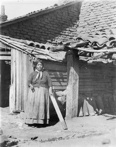 Indian woman standing near a building at Mission San Fernando