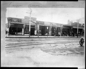 View of Spring Street near the corner of Second Street, showing a block of shop fronts, ca.1895